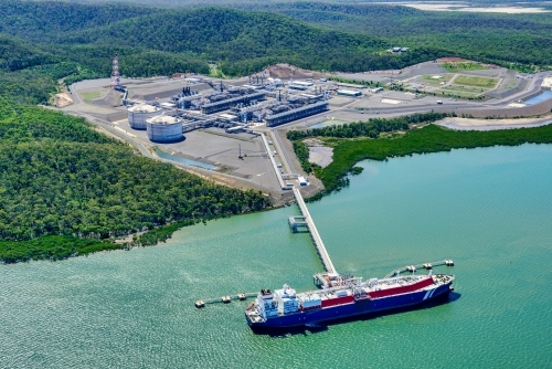 Aerial view of liquified natural gas plant and LNG ship on Curtis Island, Queensland - Australian Stock Image