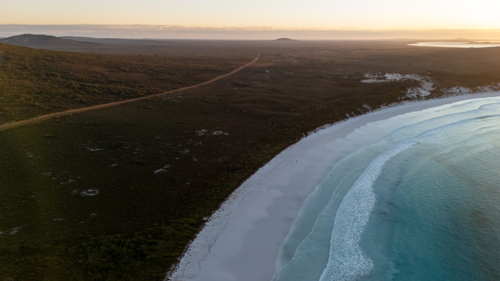 Aerial view of long stretched white sand beach - Australian Stock Image
