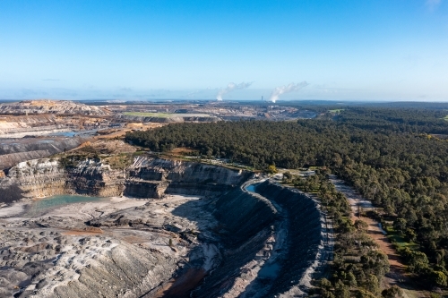 aerial view of open cut coal mine in forested area - Australian Stock Image