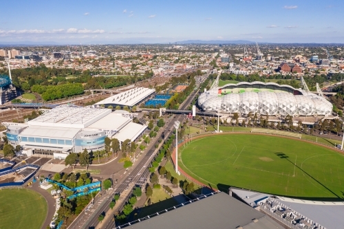 Aerial view of sports grounds and arenas along a city highway - Australian Stock Image