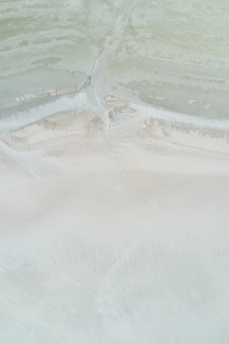 Aerial view of textures on the surface near the shore of a dry salt lake in Western Australia. - Australian Stock Image