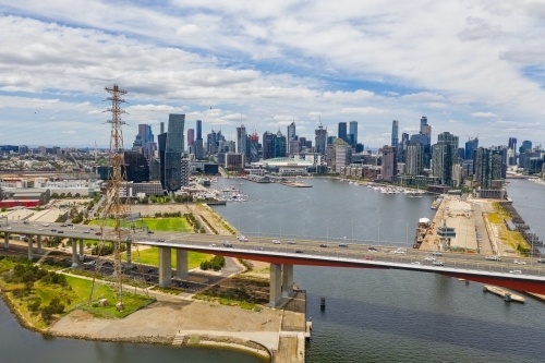 Aerial view of the Bolte Bridge over the Yarra River and Melbourne city skyline in the background - Australian Stock Image