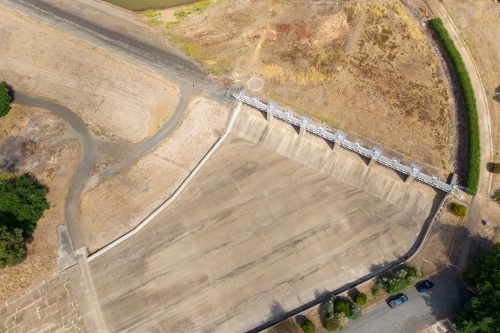 Aerial view of the dry concrete spillway of a reservoir - Australian Stock Image