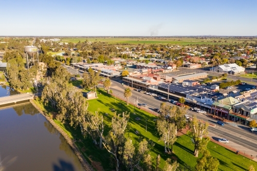 Aerial view of the main street of a regional town next to a river and parkland - Australian Stock Image