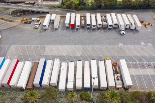 Aerial view of trucks lined up in parking bays at a ferry terminal - Australian Stock Image