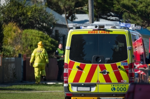 Ambulance and emergency services attend in street. - Australian Stock Image