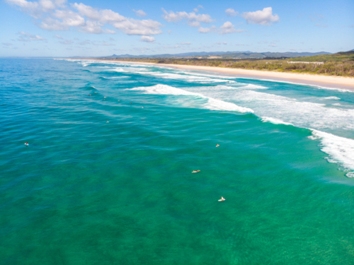 An aerial view of surfers at Cabarita Beach, Hastings Point in New South Wales, Australia - Australian Stock Image