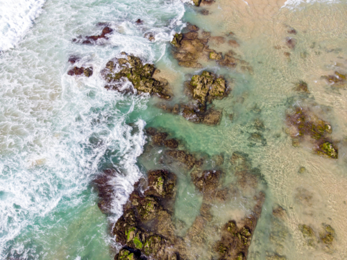 An aerial view of the coastline sea and sand on Cabarita Beach at Hastings Point in New South Wales, - Australian Stock Image