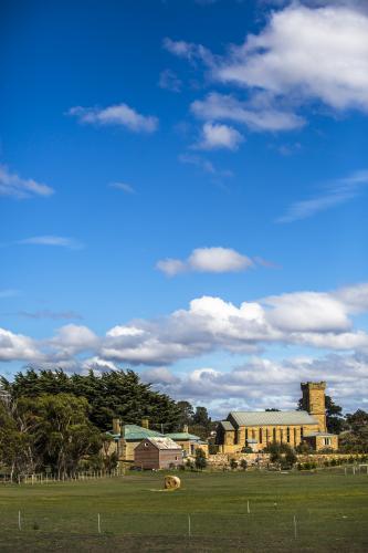 An old sandstone church amongst paddocks - Australian Stock Image