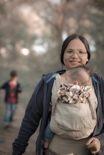 Asian mother walks with her mixed race boys in a Sydney suburban park - Australian Stock Image