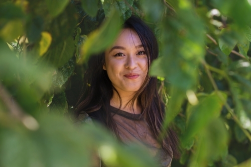 asian woman in the mulberry tree - Australian Stock Image