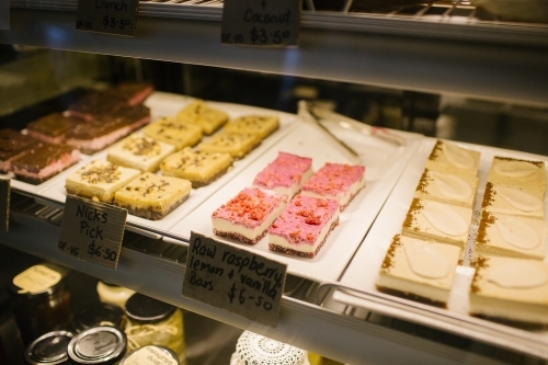 Assortment of slices through bakery window - Australian Stock Image