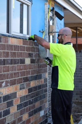 Tradie working on house building site