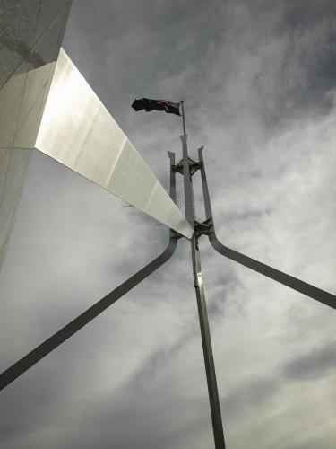 Australian Flag flying at Parliament house seen from below