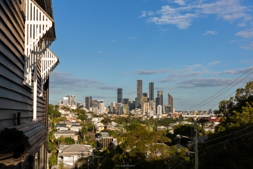 awnings over windows on a timber Queenslander with Brisbane City - Australian Stock Image