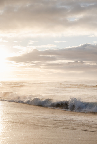 backlit sunrise waves - Australian Stock Image
