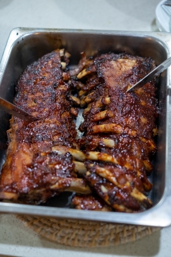 barbecued pork ribs in a dish - Australian Stock Image