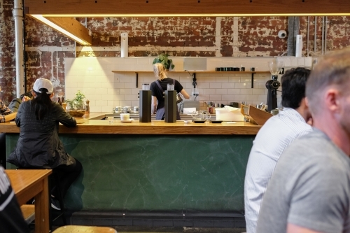 Barista and customers in coffee shop - Australian Stock Image