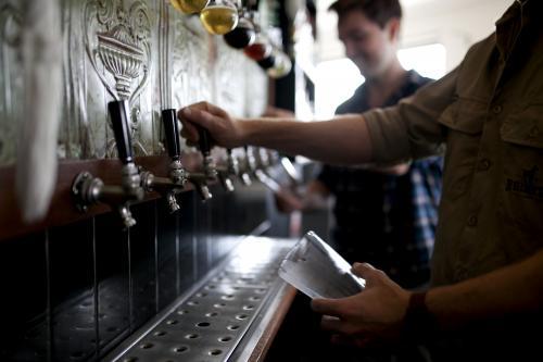 Bartenders pouring drinks at local craft beer bar