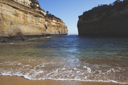 Beach nestled in cliffs - Australian Stock Image