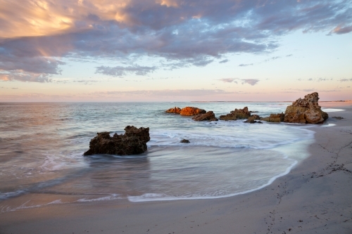 beach sunrise with rocks - Australian Stock Image