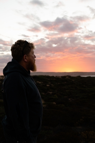 Bearded man gazing into the sunset - Australian Stock Image