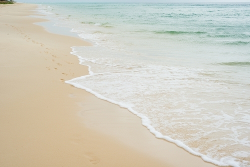 Beautiful clear water lapping the shore at the beach - Australian Stock Image