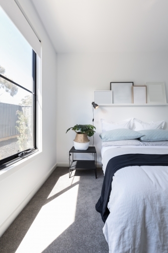 Beautiful sunlight beaming into a luxuriously styled bedroom