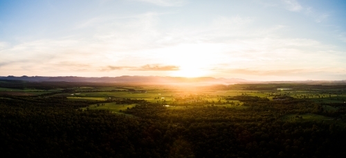 Beautiful sunset light over landscape of trees and farm land in Hunter Valley - Australian Stock Image