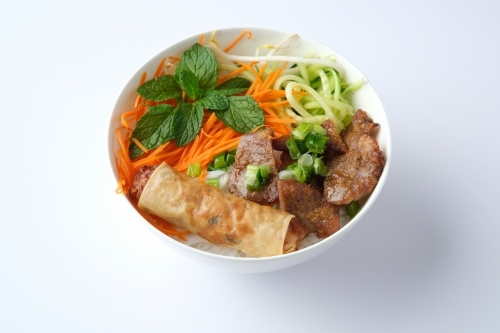 Beef noodle salad topped with fried lumpia - Australian Stock Image