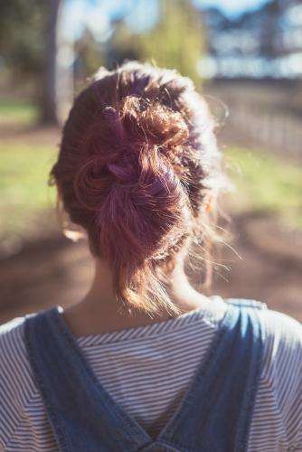 behind view of teenager with purple colour in her hair