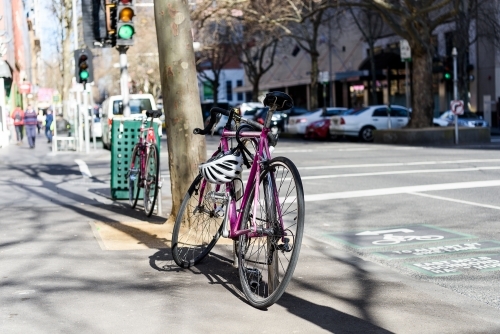 Bicycle parked on side of street in Melbourne City: Aug 2017. - Australian Stock Image