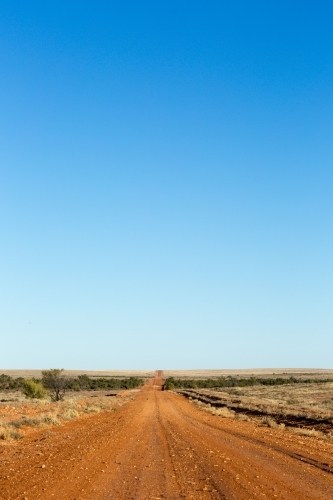 Big blue sky with red dirt road in the outback