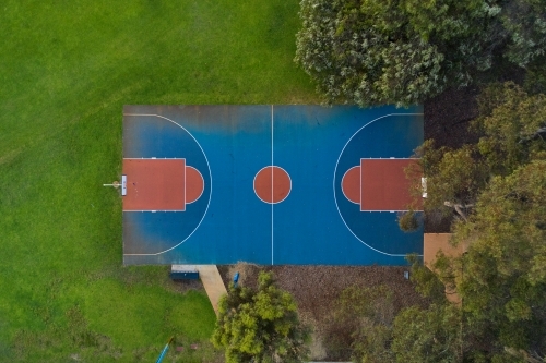 Bird's eye view of a community basketball court in a park.