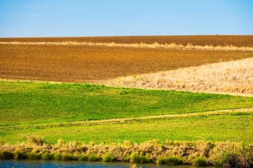 Blocks of coloured land on the side of a hill that is used for agriculture in Kalbar,  Australia. - Australian Stock Image