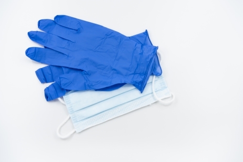 Blue gloves and surgical mask flatlay - Australian Stock Image