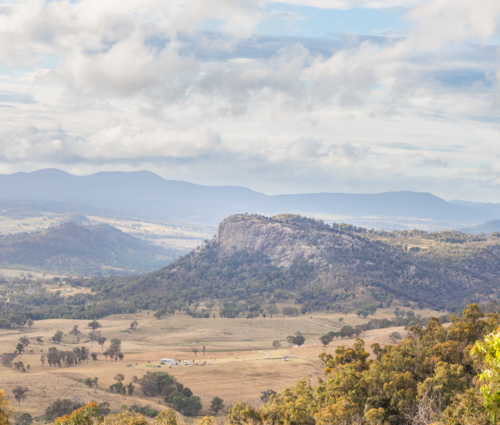Bluff Rock, a granite outcrop overlooking brown country fields underneath a cloudy sky - Australian Stock Image