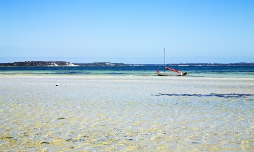 Boat anchored in shallow water - Australian Stock Image