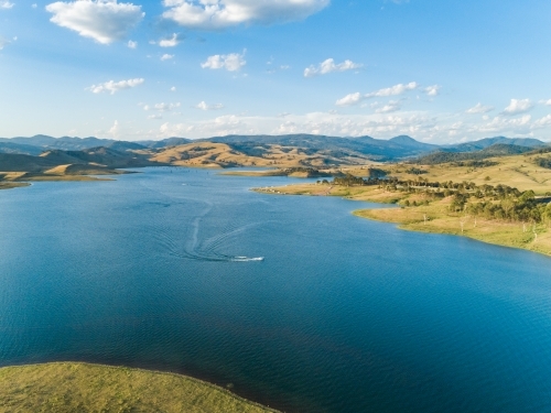 Boat out on blue lake in Hunter Valley recreational area - Australian Stock Image