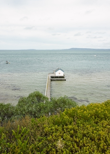 Boat shed at the end of a long jetty - Australian Stock Image