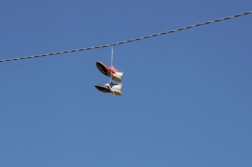bowling shoes hanging on an electrical wire - Australian Stock Image