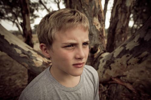 Boy in the bush - not smiling - Australian Stock Image