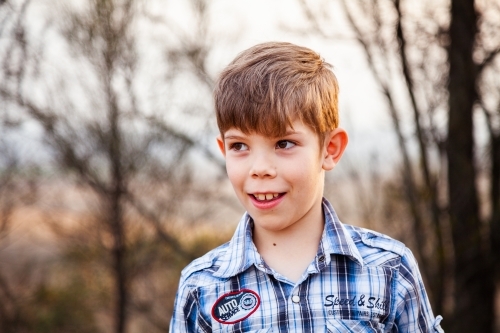 Boy outside in orange light caused by bush fires - Australian Stock Image