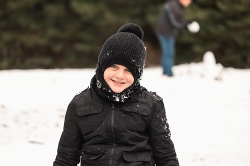 Boy playing in the snow at Shooter's Hill, NSW - Australian Stock Image