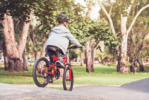 Boy riding his bicycle on Parklands bike track in Adelaide, South Australia - Australian Stock Image