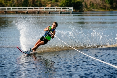 Boy water skiing on lake - Australian Stock Image