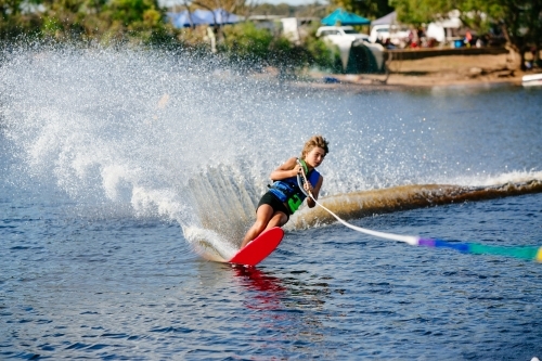 Boy water skiing on lake