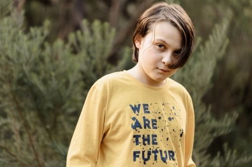 Boy wearing a generic yellow T-shirt that says we are the future - Australian Stock Image