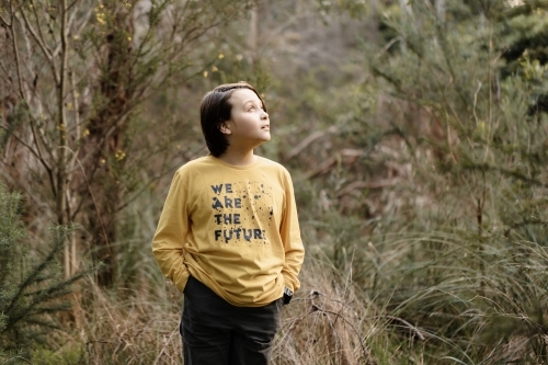 Boy wearing a generic yellow T-shirt that says we are the future - Australian Stock Image