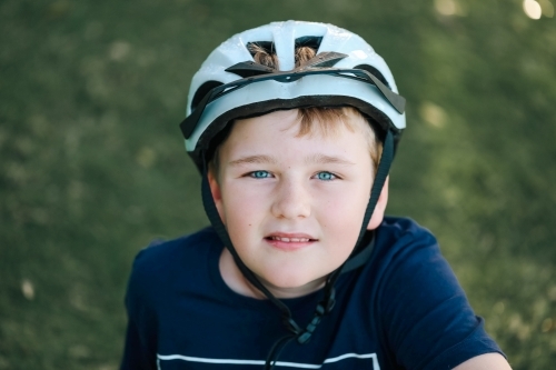 Boy wearing bike helmet at the park - Australian Stock Image